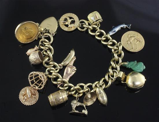 An 18ct gold curblink charm bracelet hung with fifteen assorted charms including 9ct gold and gold plated.